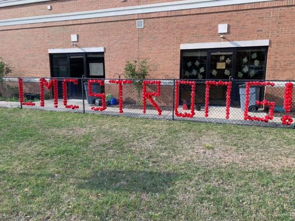 The words LMC Strong  written on a fence.