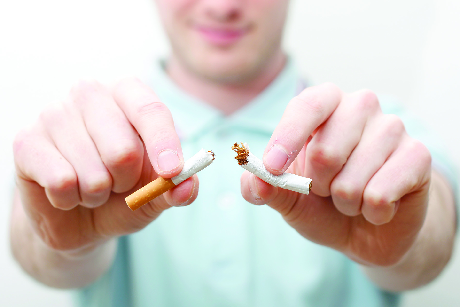 Man breaking cigarette
