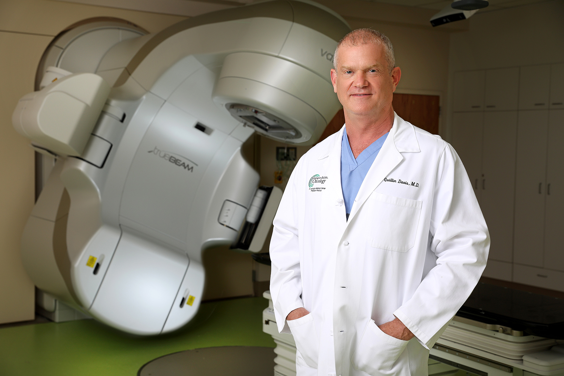 Dr. Davis standing in front in linear accelerator