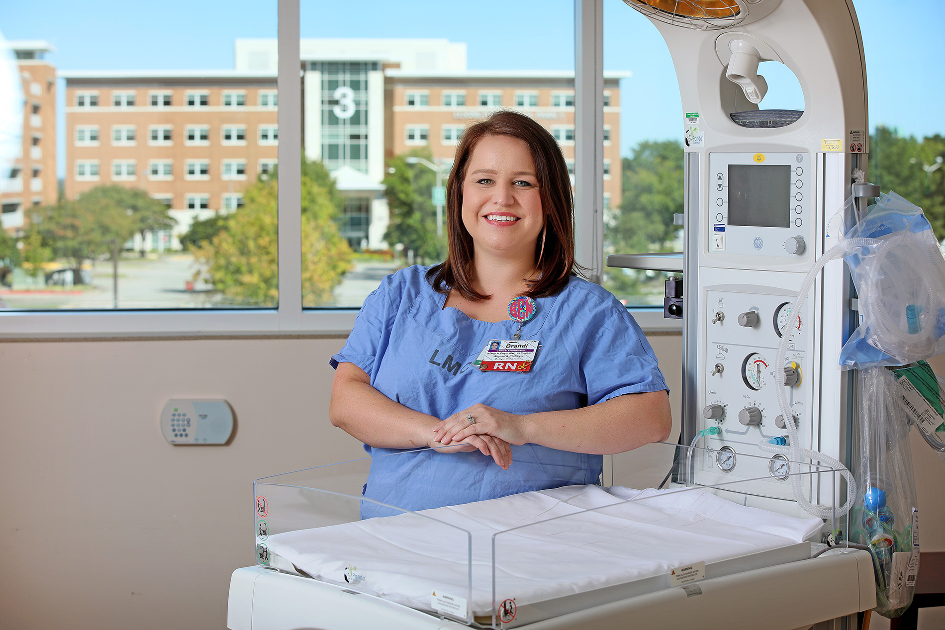 Brandi Ellisor standing in front of infant isolette