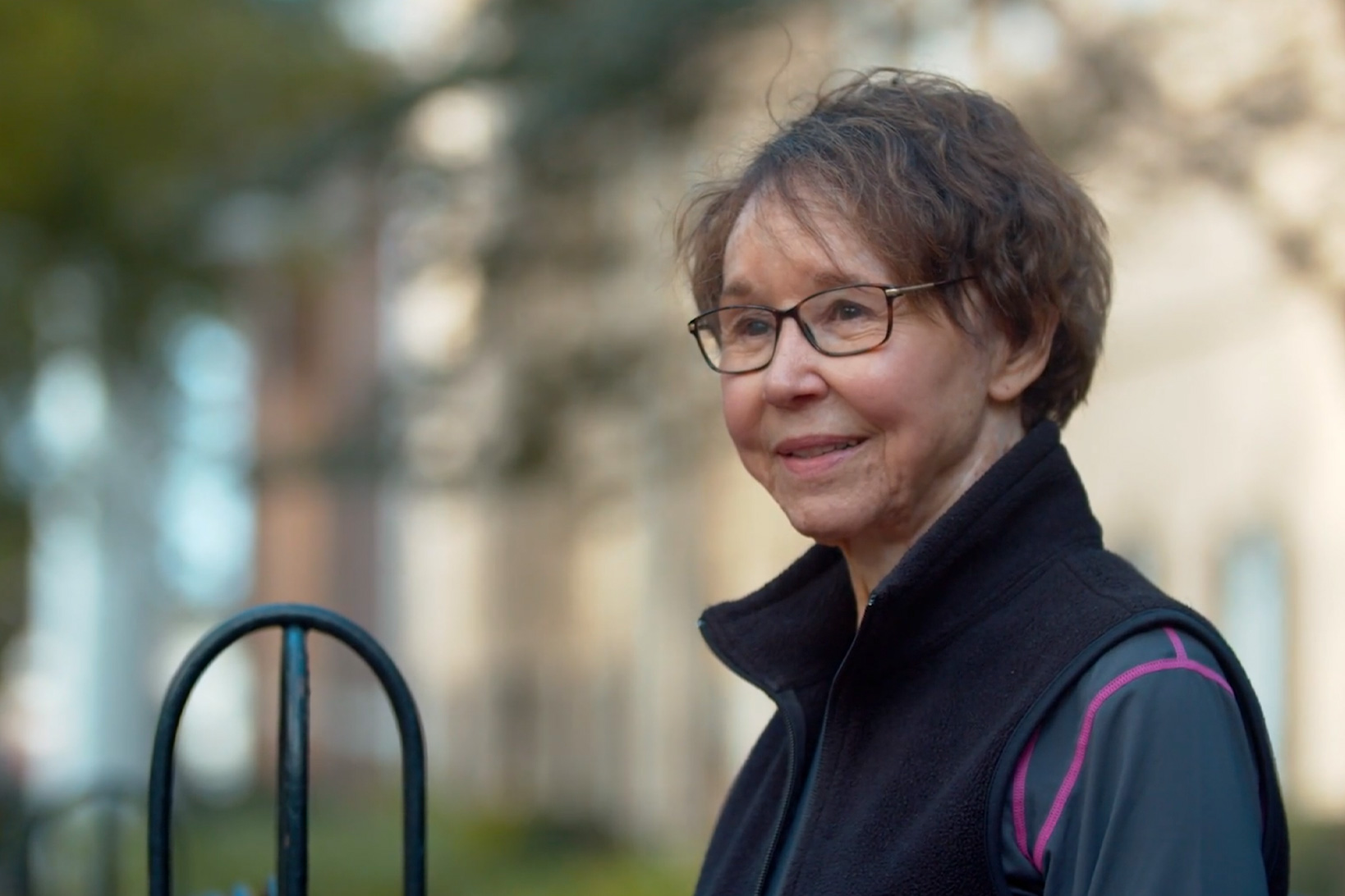Fixing A Broken Heart Patient Mary Ann Parsons, smiling slightly, as she sits on a bench in the University of South Carolina Horseshoe park.