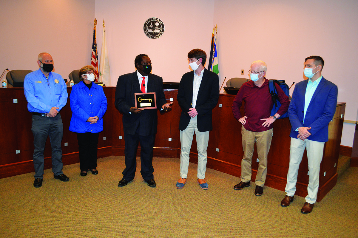 Rob Willm accepting key to city award from Irmo mayor and council members