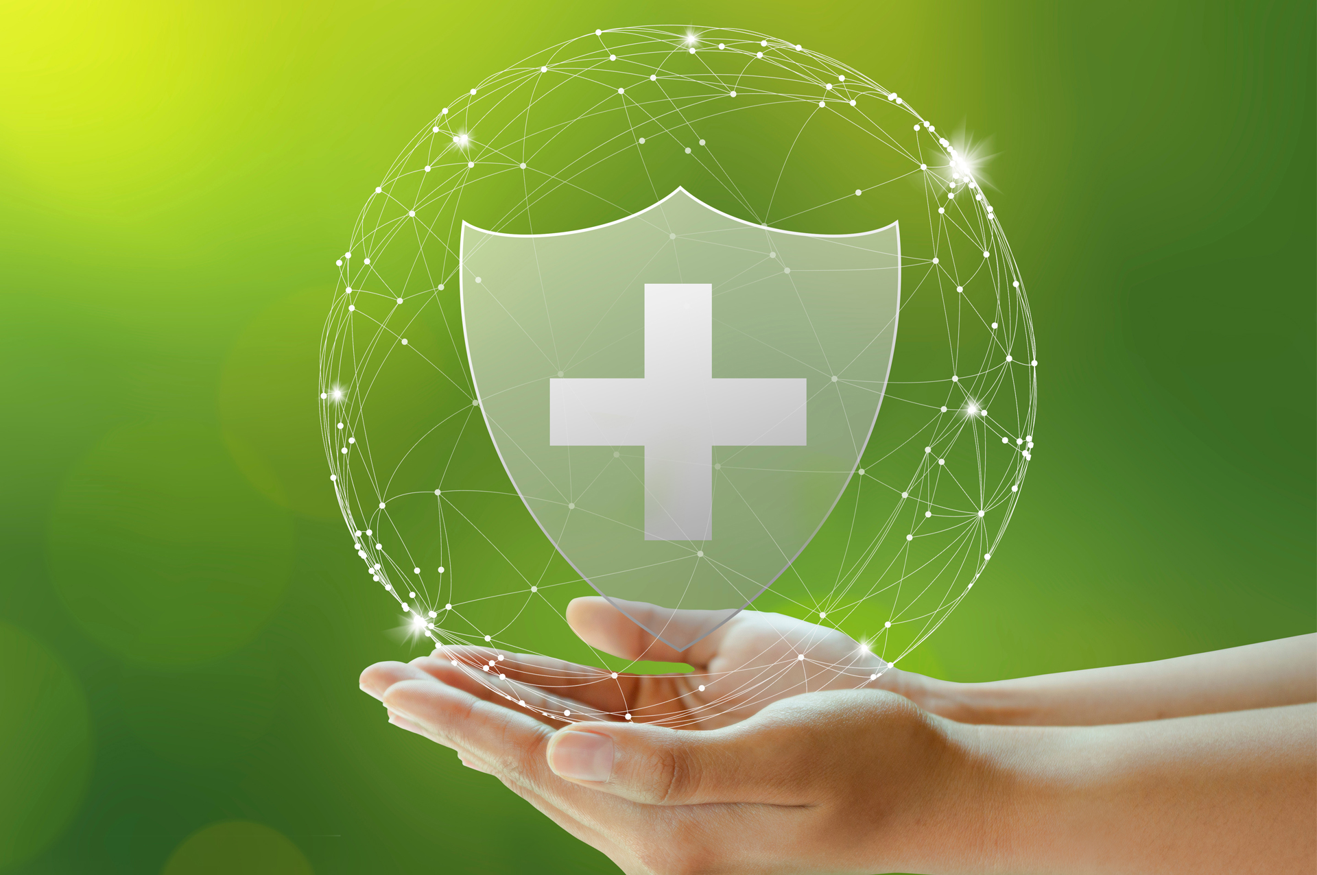 Woman's hands holding an medical cross symbol against green background