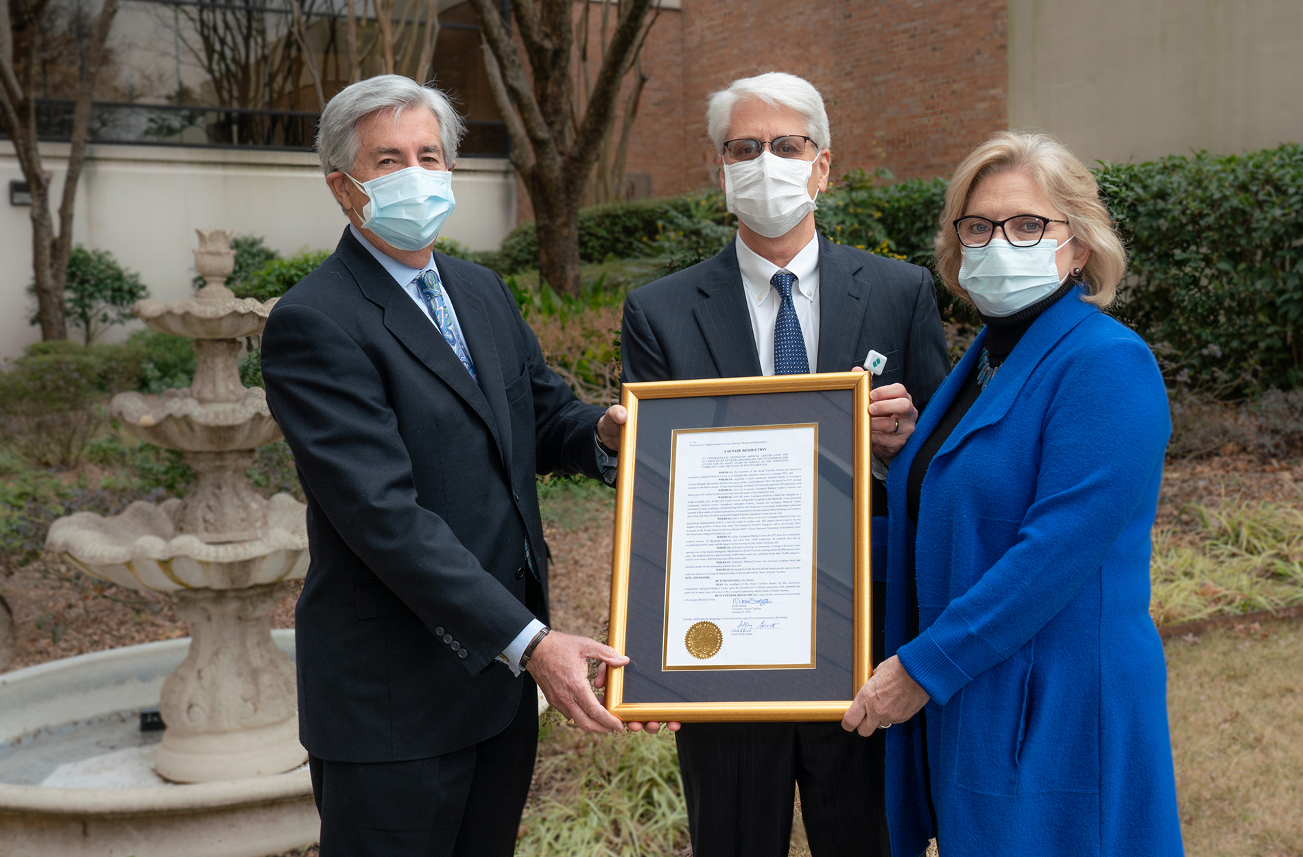 Sen. Setzler and Sen. Shealy present proclamation to LMC CEO