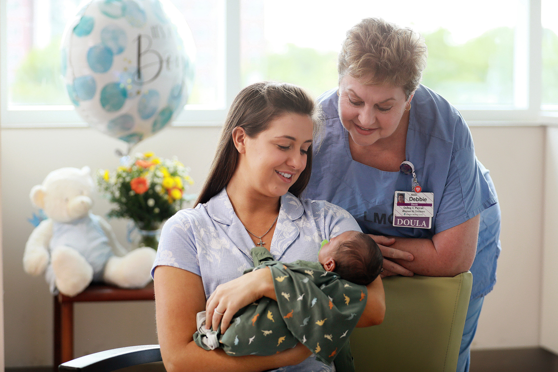Doula with new mother and her baby in the hospital room