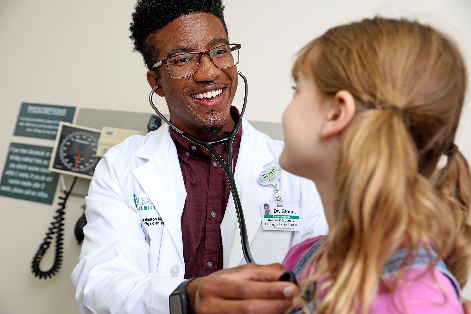 Dr. Roman Blount examining young patient