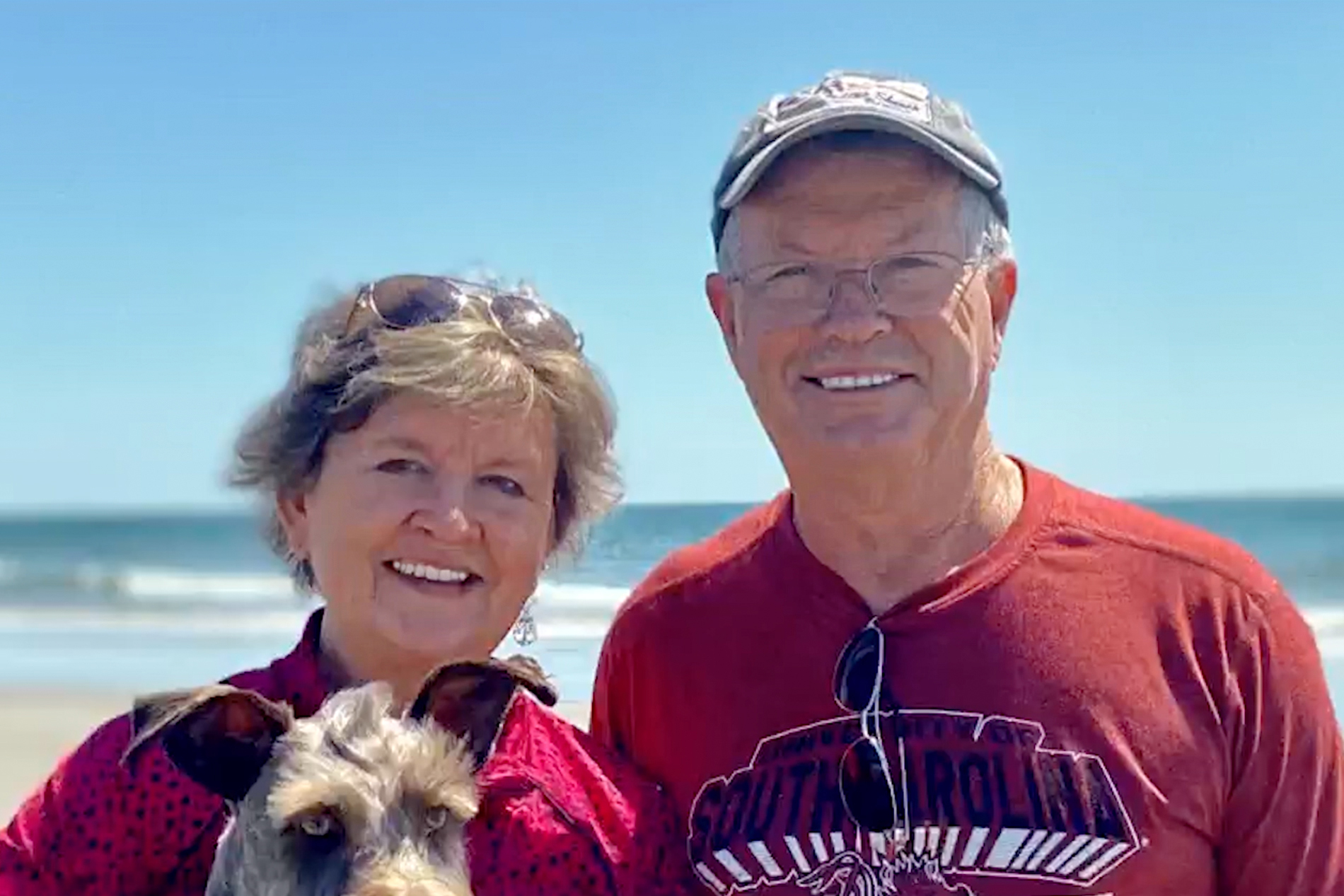 Steve and Mamie Turner on the beach with their dog