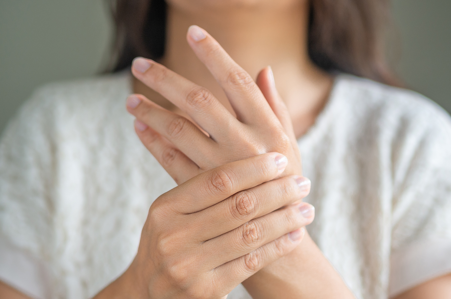 Woman holding her painful wrist