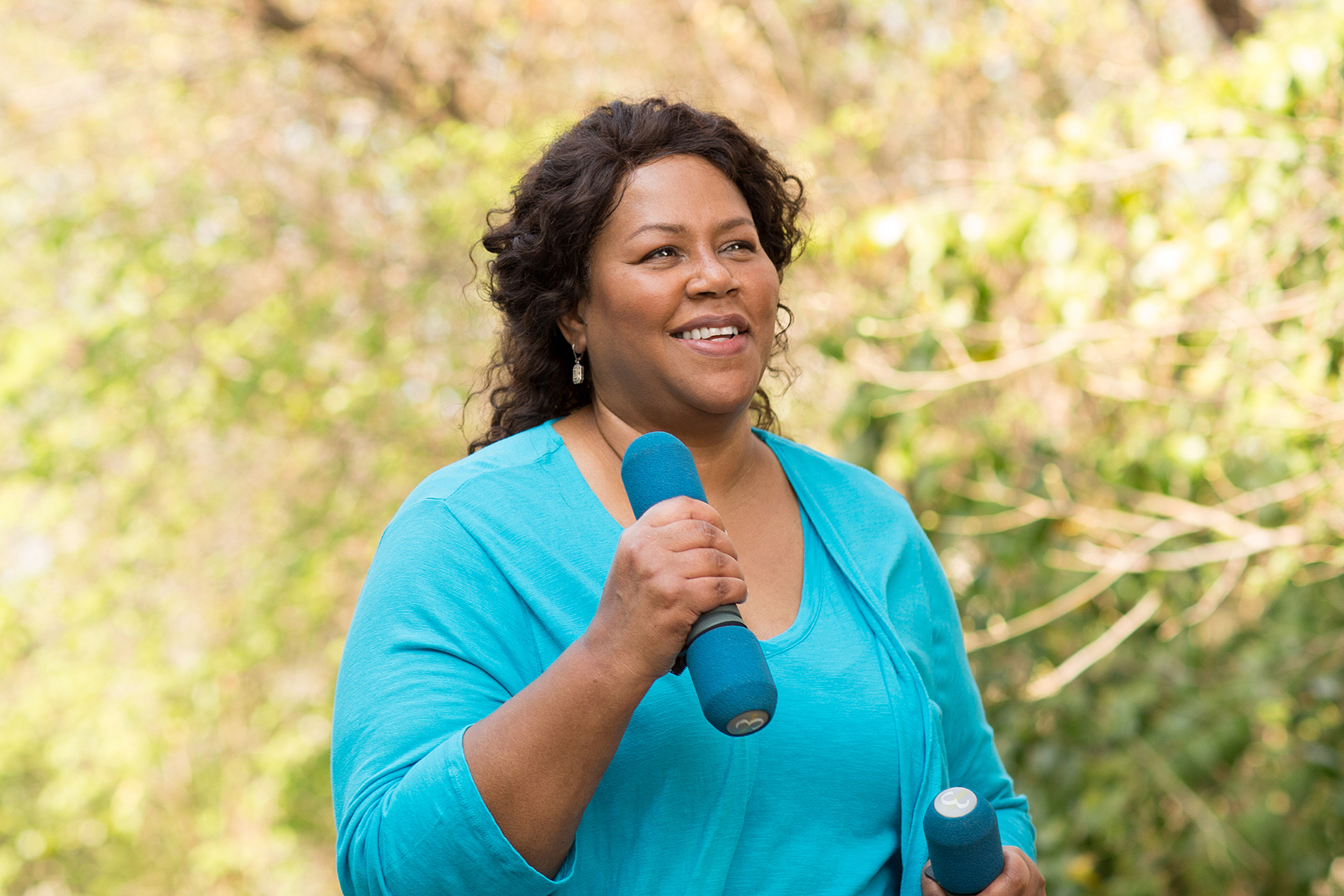 Overweight woman walking with hand weights