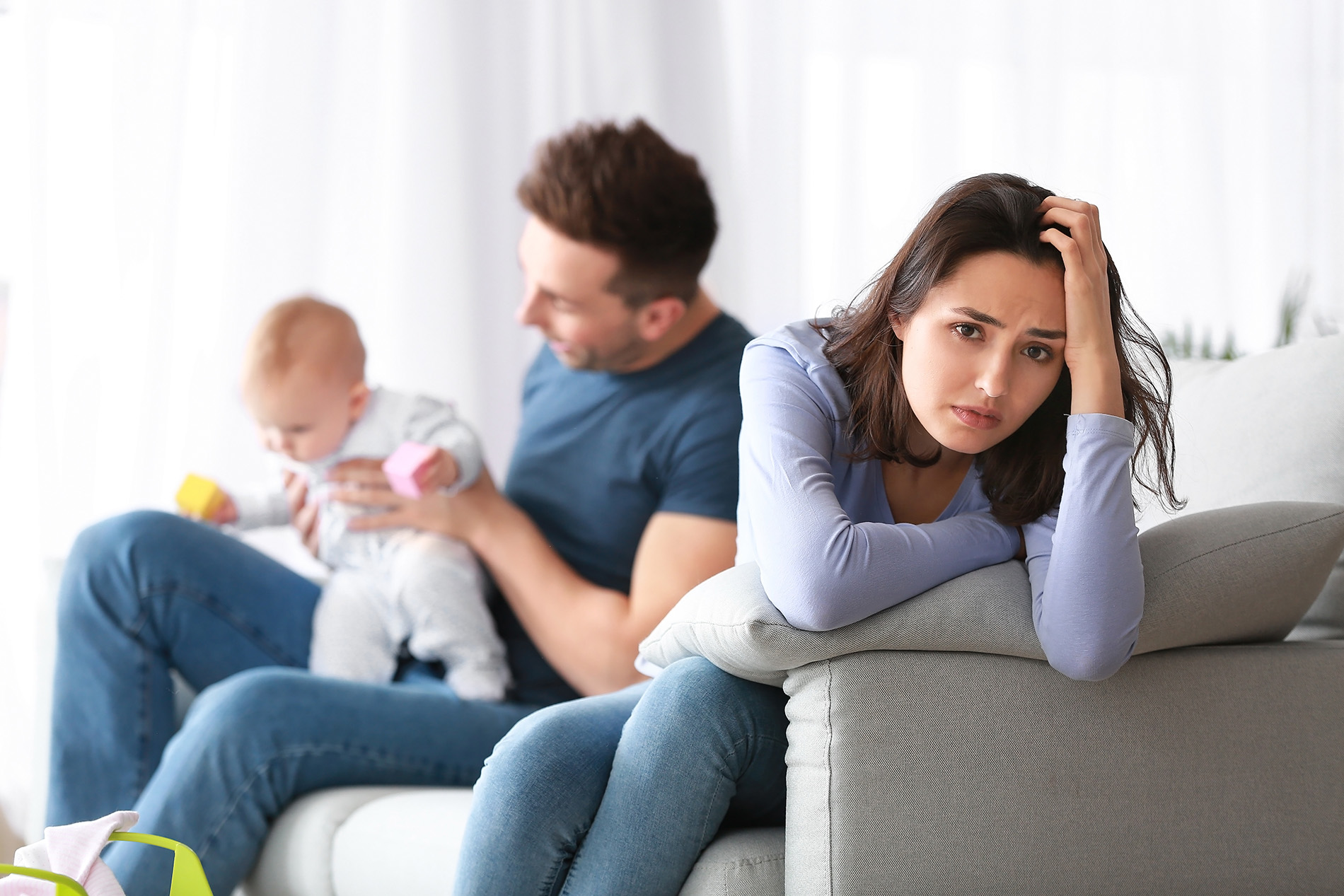 Sad young mother with baby and baby's father