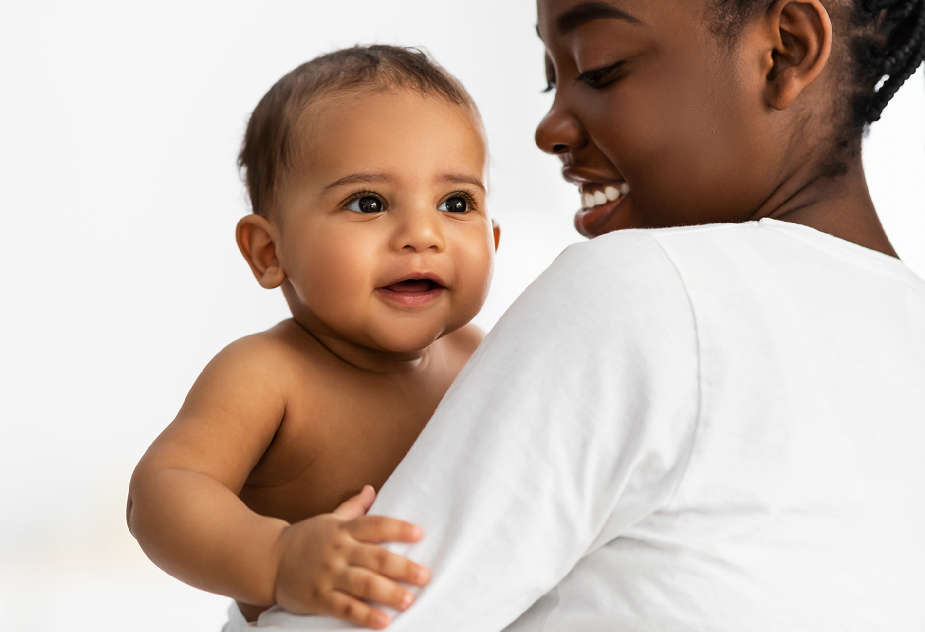 Mom holding smiling baby