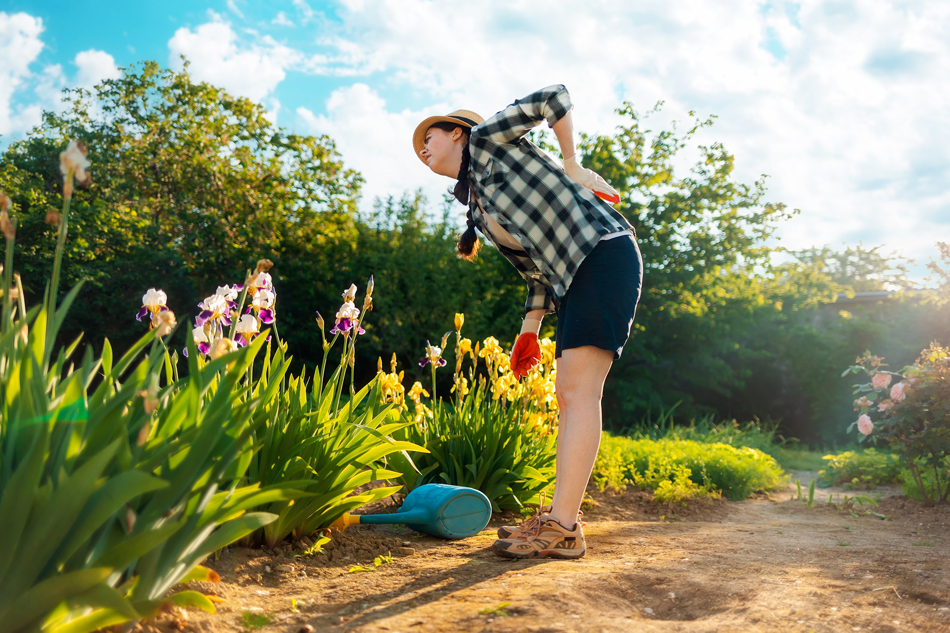 Woman gardening bending over with back pain