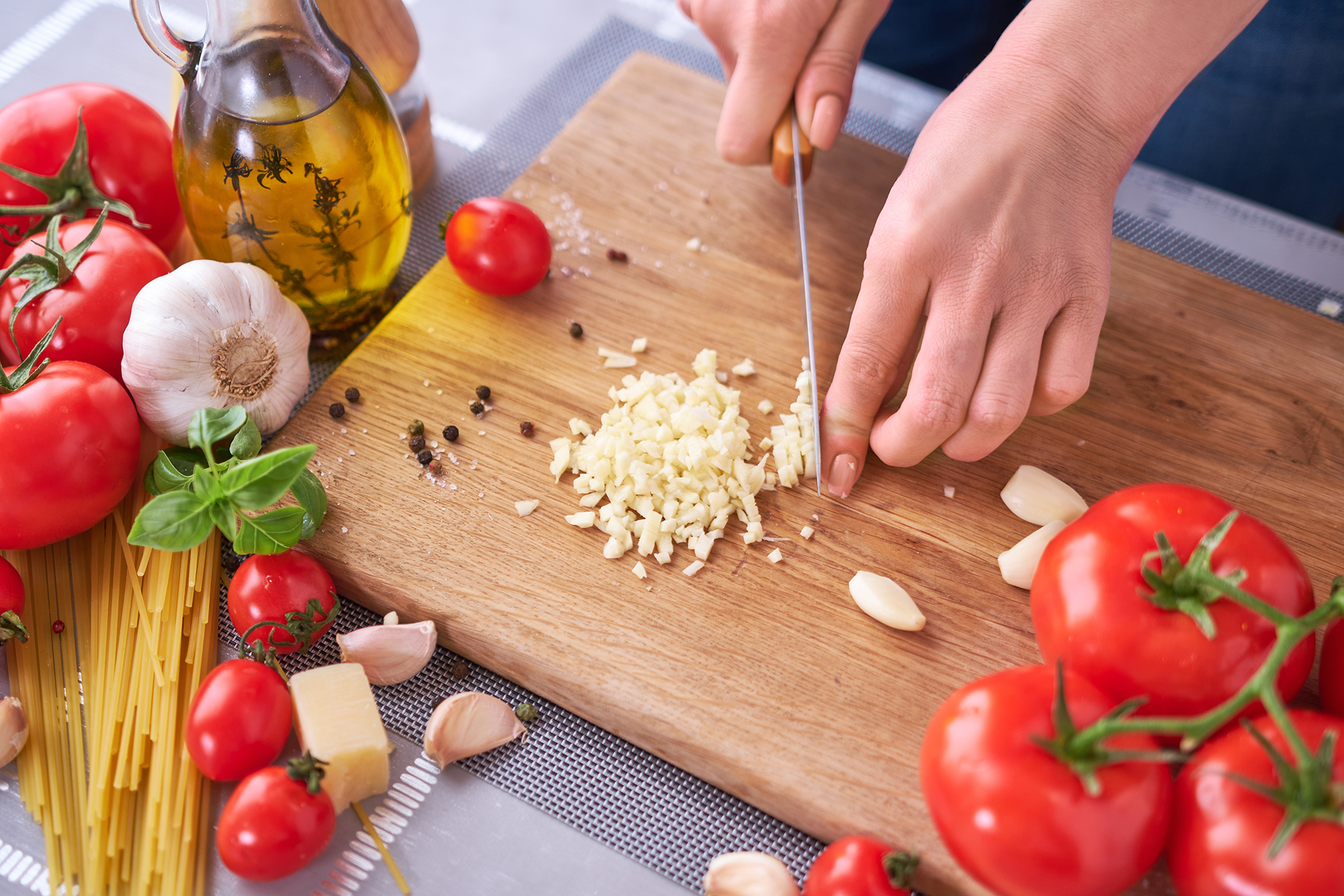 Woman's hands chopping garlic
