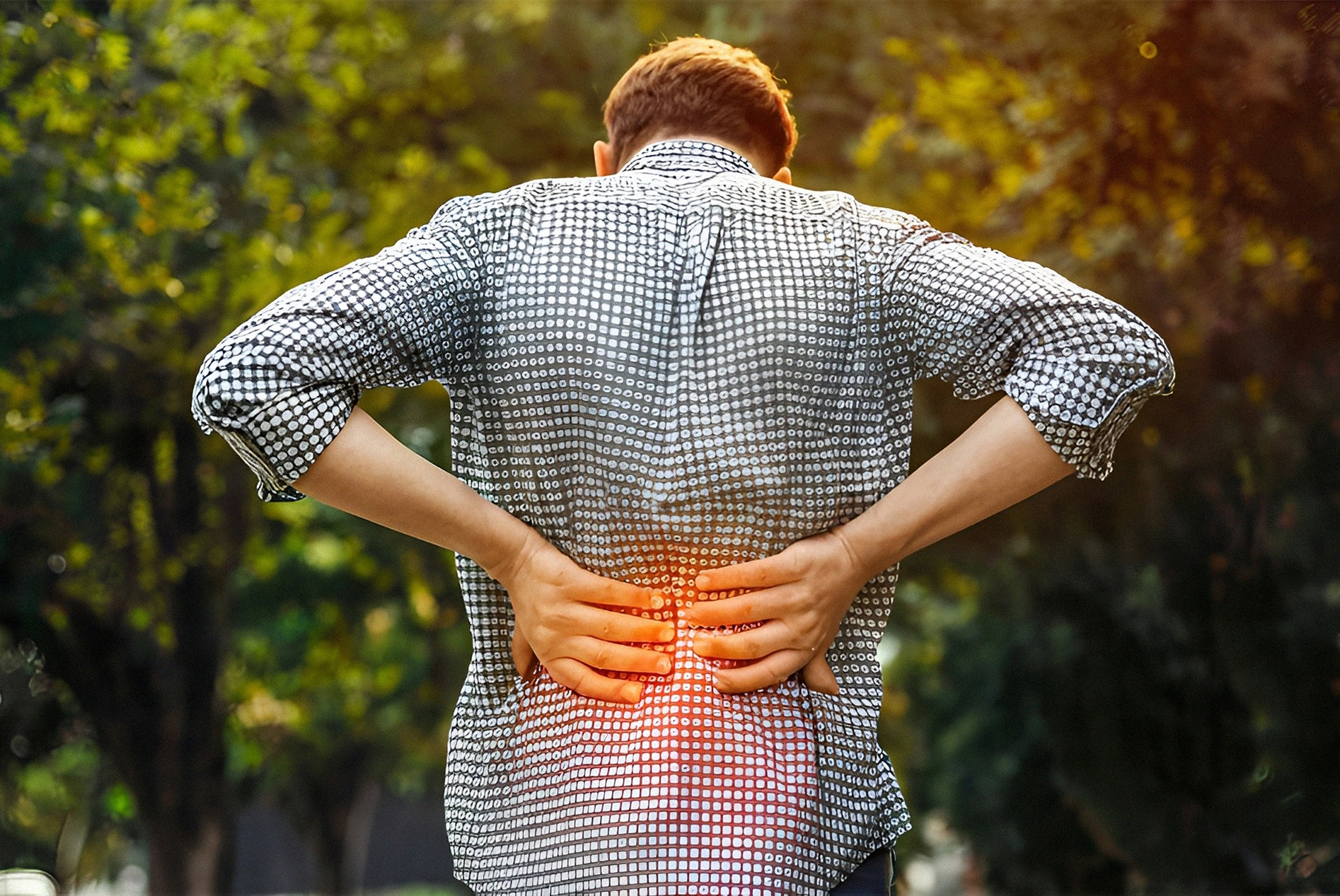 Man outside holding his flanks due to kidney stone pain