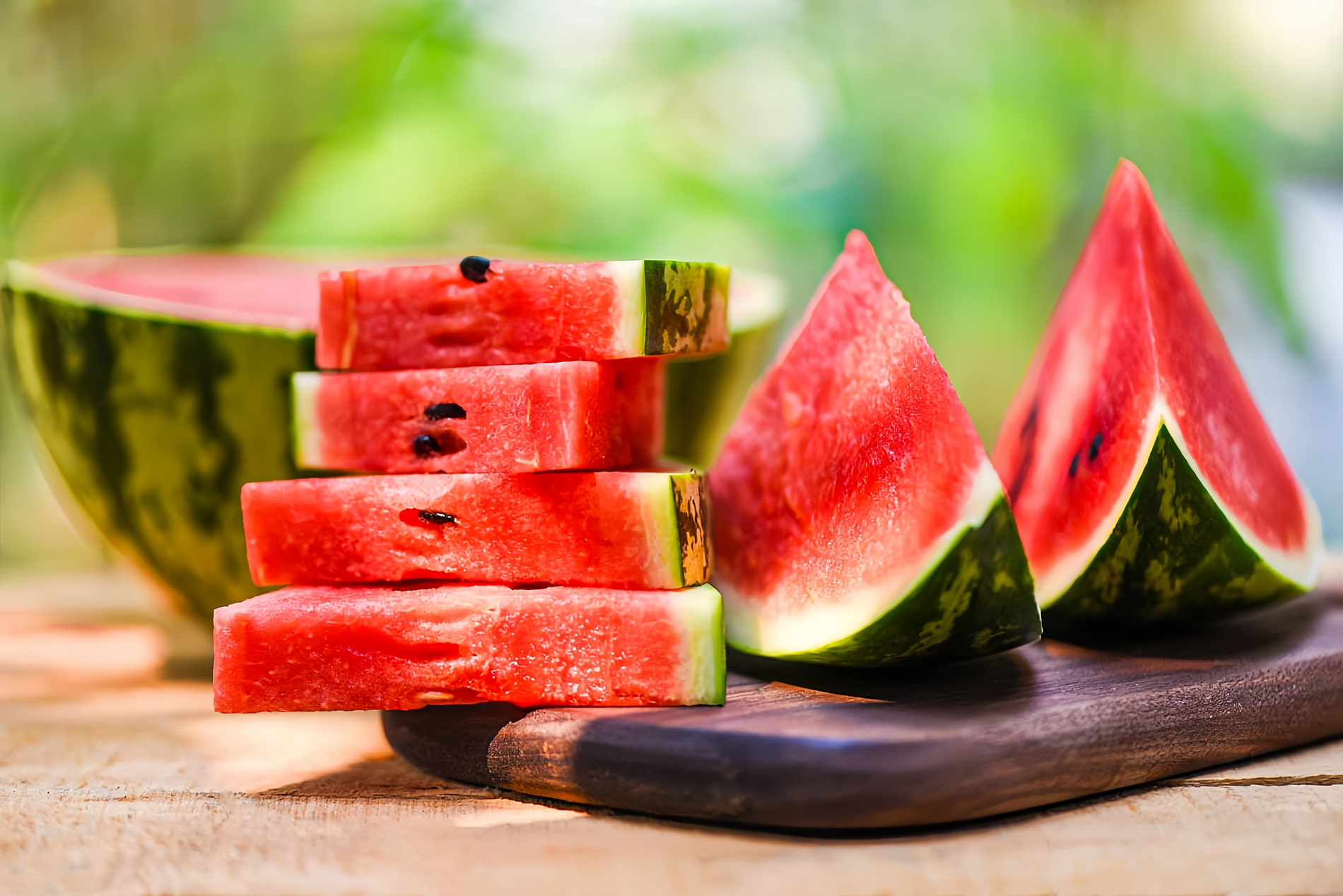 slices and wedges of watermelon on outdoor table