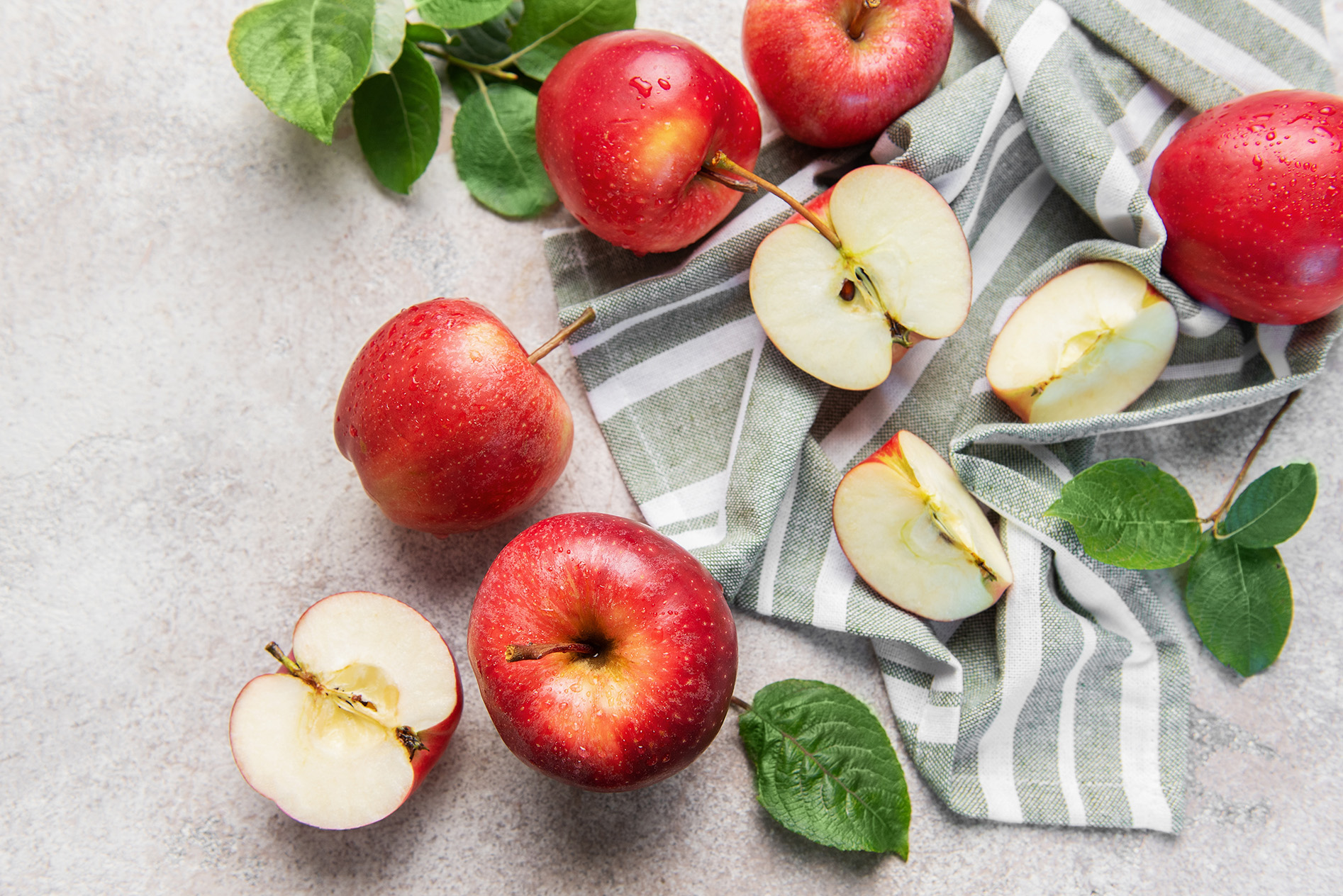 red apples on black and white dish towel
