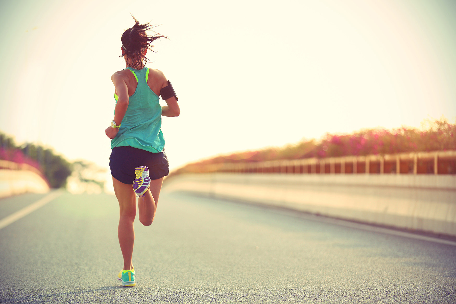 Woman running across bridge