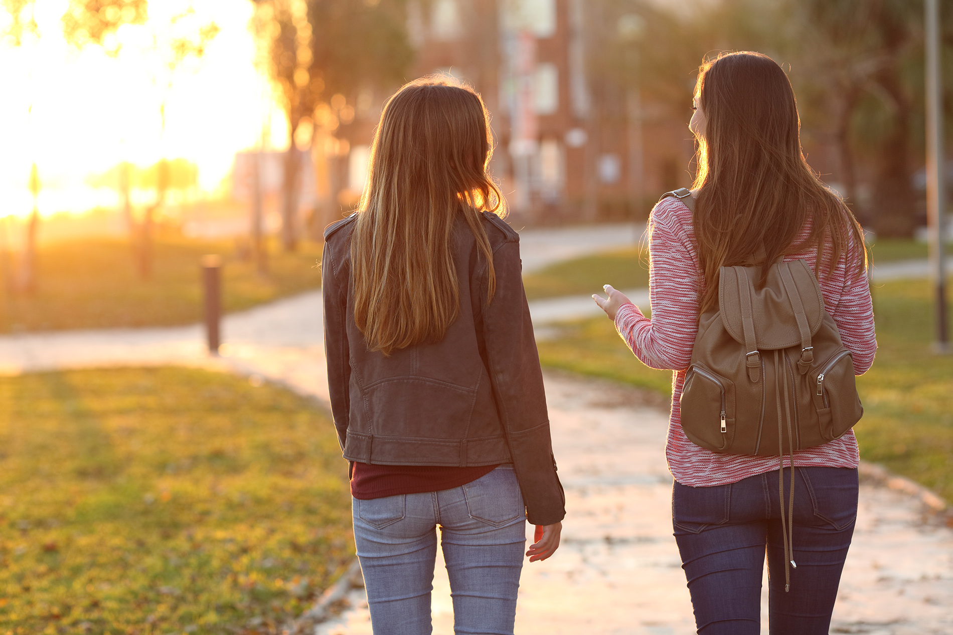 Teens girls walking with backpacks