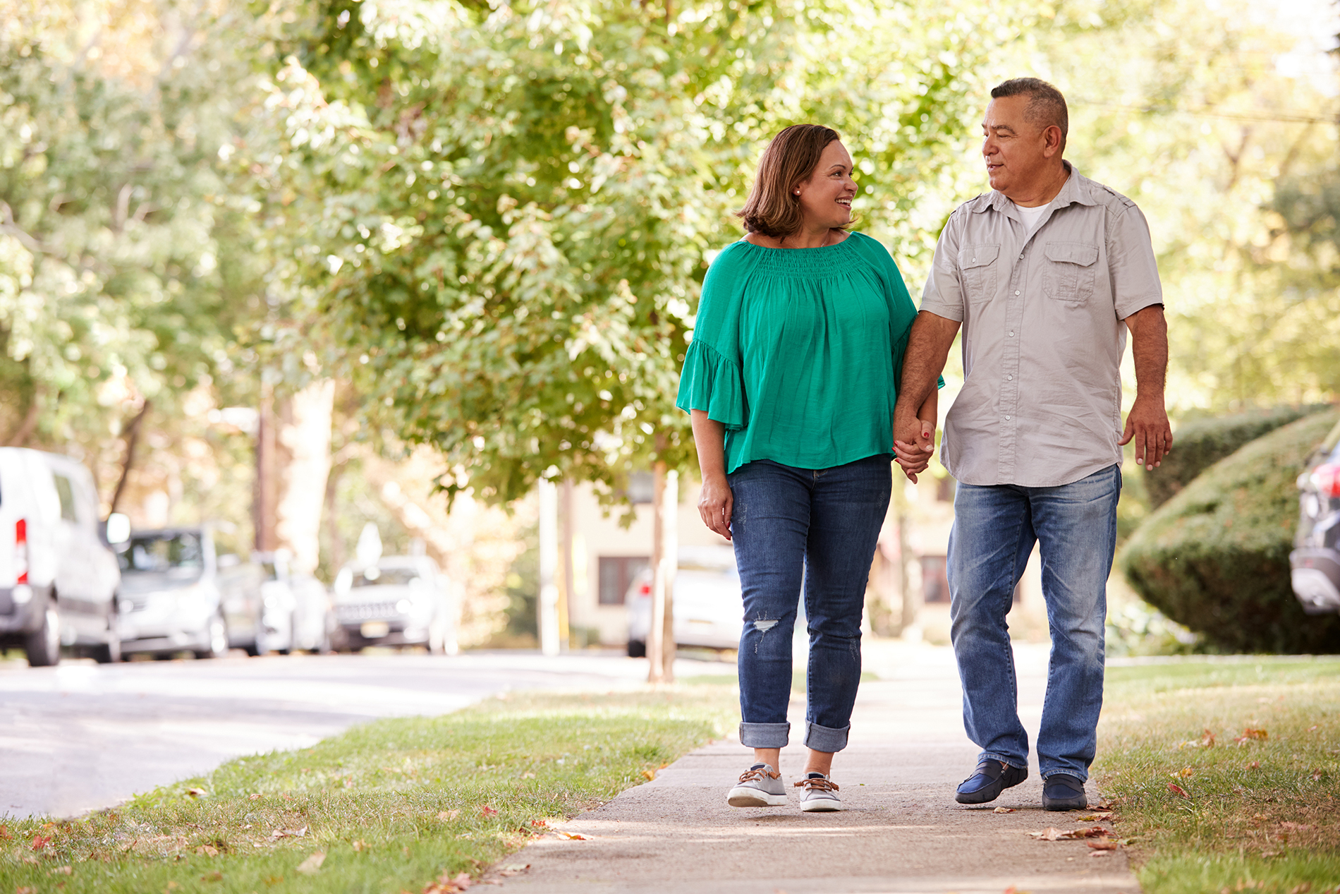 Hispanic couple walking in neighborhood