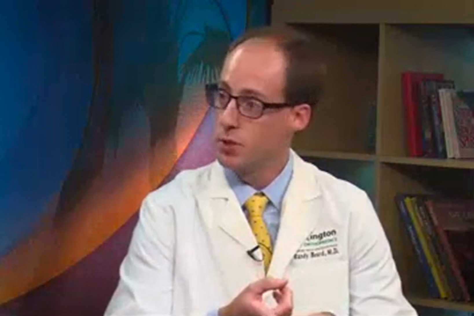 Dr. Beard speaking and gesticulating during an interview on the set of WLTX.