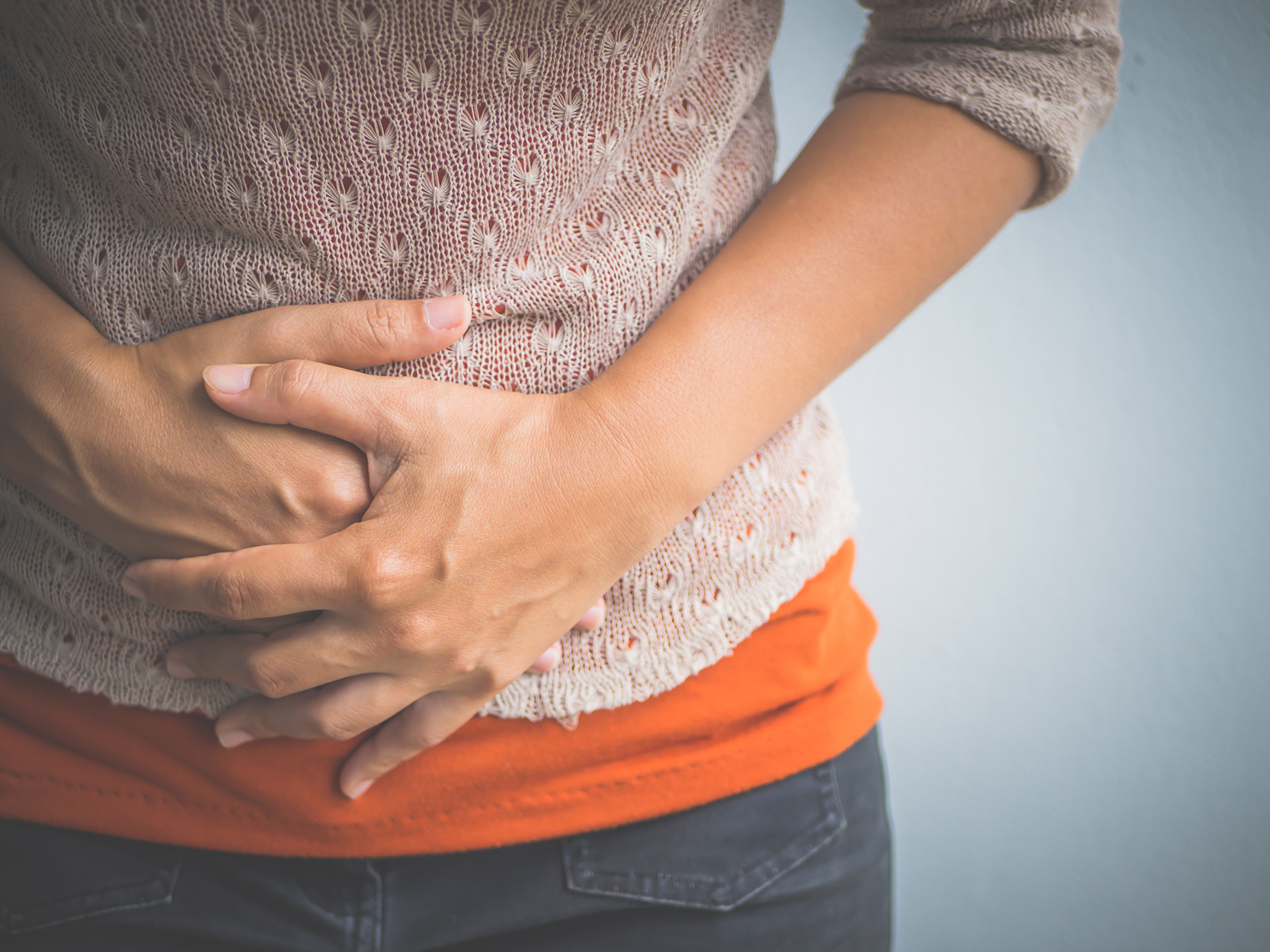Woman holding abdomen