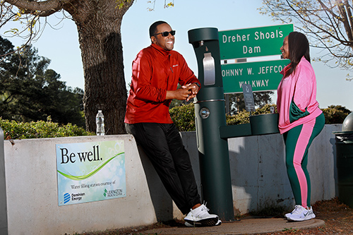 Couple by Be Well water fountain at Lake Murray Dam