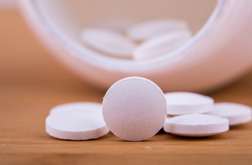 Pills in Bottle White pills pouring out of pill bottle